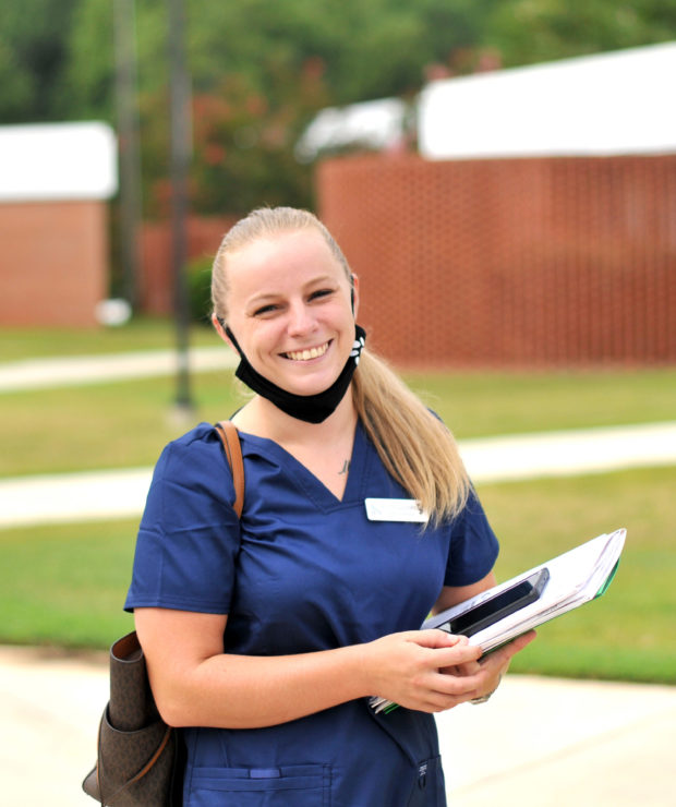 Student in scrubs outside college. Credit: Central Carolina Community College (CCCC)
