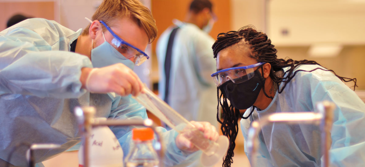 Two students watch chemical reaction in protective gear. Credit: Central Carolina Community College (CCCC)