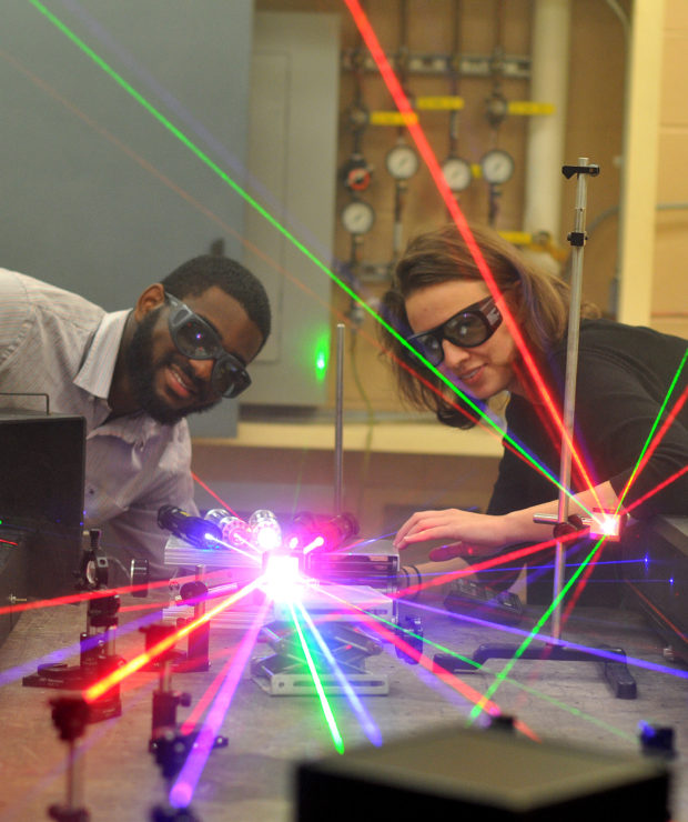 Two people work on coordinating scientific lasers. Credit: Central Carolina Community College (CCCC)
