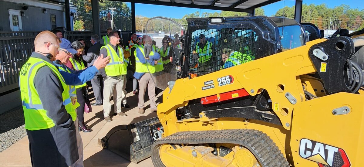construction equipment with a crowd gathered