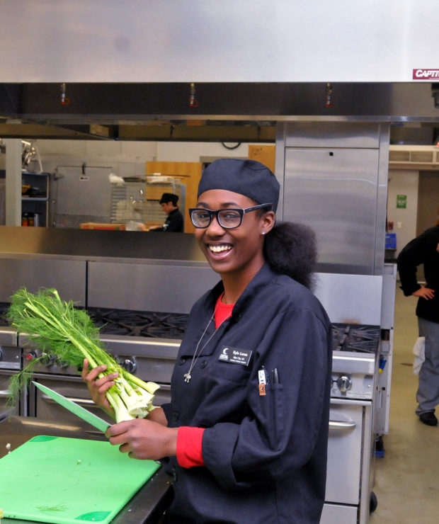 Student in culinary school cutting herbs. Credit: Central Carolina Community College (CCCC)