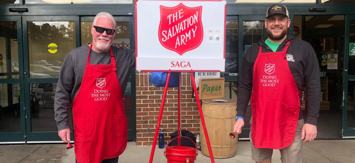 Two people raise money for the Salvation Army outside of grocery store.