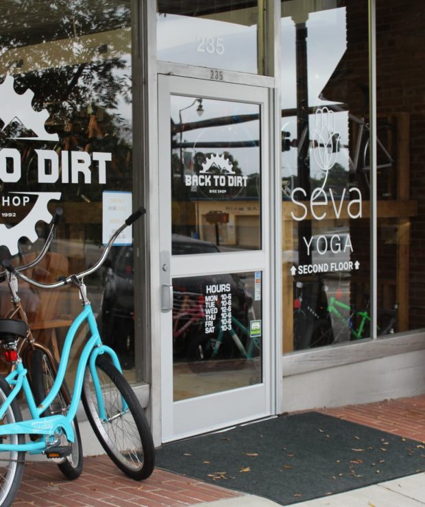 Storefront windows for Back to Dirt and Seva Yoga.