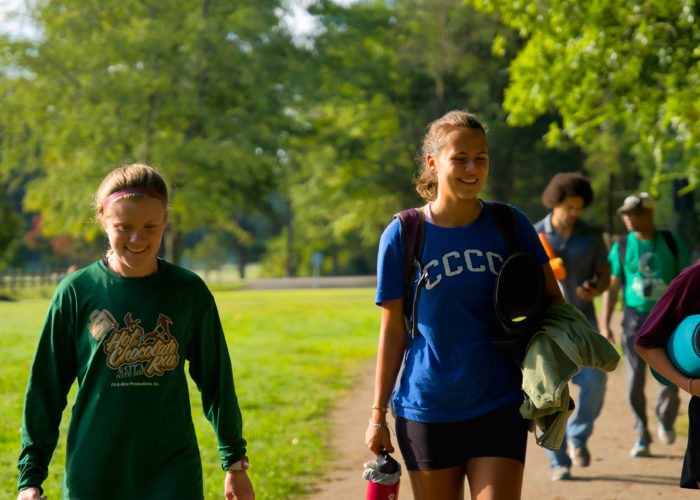 Student athletes walk on outdoor trail. Credit: Ahmod Goins