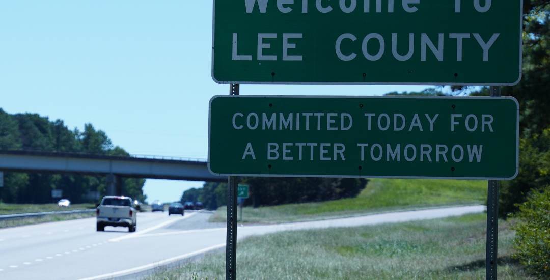 a sign by a freeway that says 